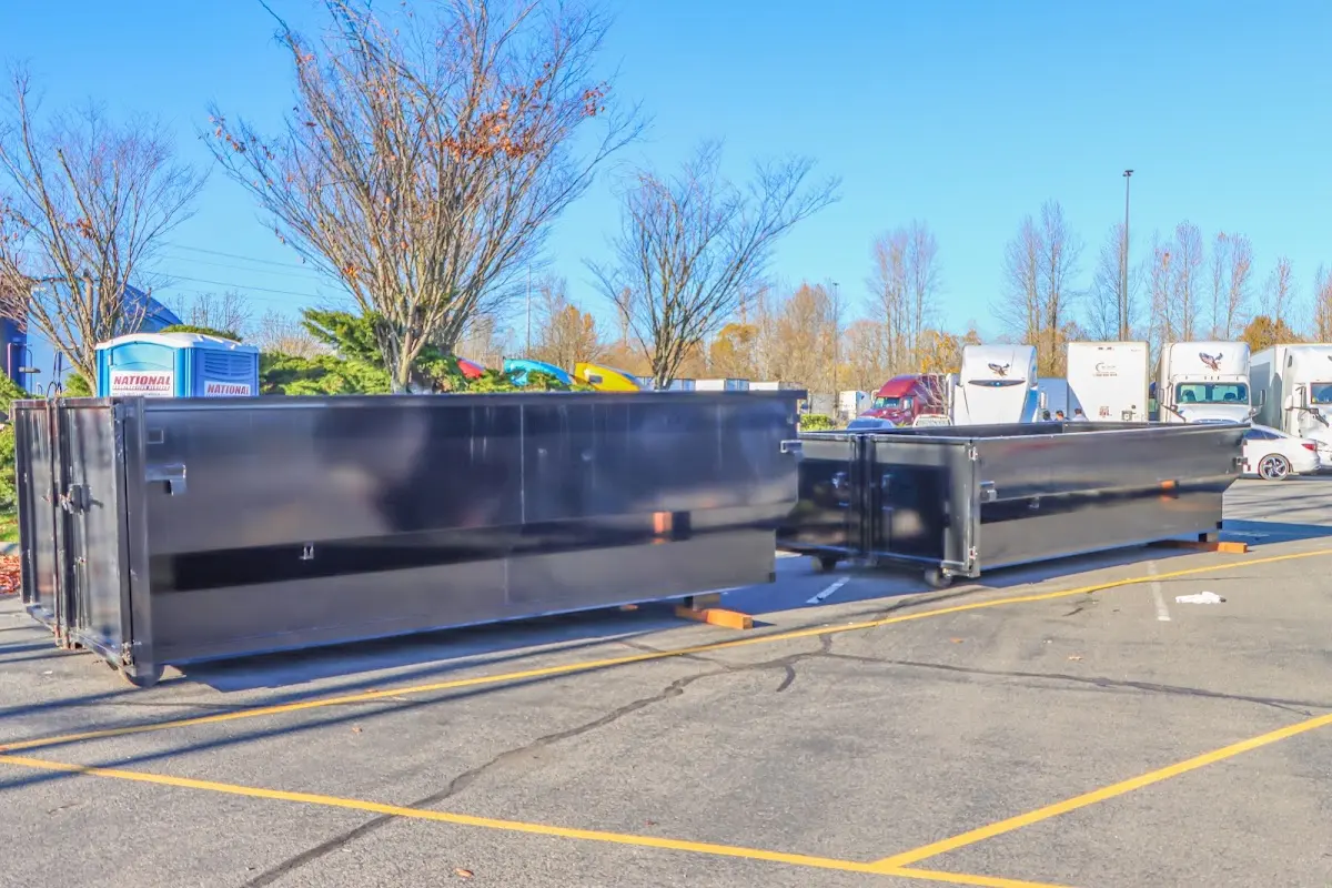 Professional dumpster rental service with roll-off container on residential driveway in Fountain Hills